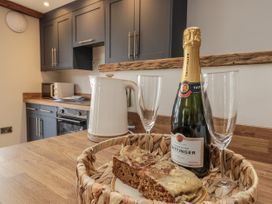 A kitchen with a kettle and champagne in glasses at Betsy's Burrow 