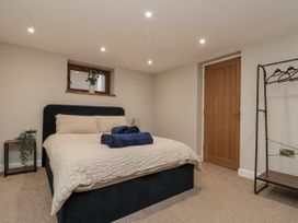 A bedroom with a bed and bedside table at Betsy's Burrow