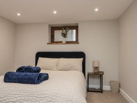 A bedroom with a bed and towels on it at Betsy's Burrow