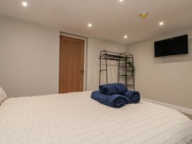 A bedroom with a bed and towels at Betsy's Burrow