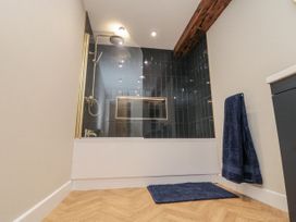 A bathroom with a bathtub and shower at Betsy's Burrow