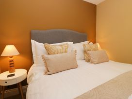 A bedroom with a bed and bedside table at Jenny's in Hawkshead
