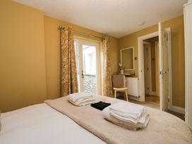 A bedroom with a bed and towels at Jenny's in Hawkshead