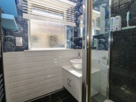 A bathroom with a shower and sink at Ty Glan Morfa in Morfa Bychan