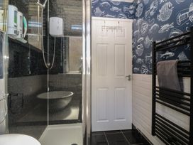 A bathroom with a shower and a towel radiator at Ty Glan Morfa in Morfa Bychan