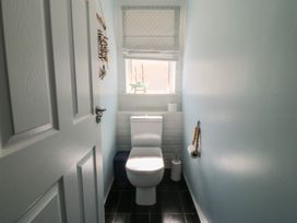 A bathroom with a toilet and sink at Ty Glan Morfa in Morfa Bychan