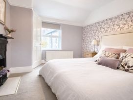 A bedroom with a bed and window at Waterfall Cottage in Dyserth