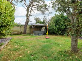 A garden with a playset and hot tub at Valley Pines in Valley