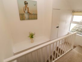 A hallway with a painting and a flower vase at Meledor in Marazion