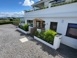 A garden area with plants and gravel path at Top Of The Lane Luxury Holiday Apartment in Benllech