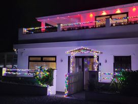 A house decorated with colorful lights at Top Of The Lane Luxury Holiday Apartment in Benllech