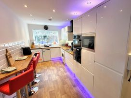 A kitchen with cabinets and a sink at Top Of The Lane Luxury Holiday Apartment in Benllech