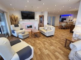 A living room with a coffee table and television at Top Of The Lane Luxury Holiday Apartment in Benllech