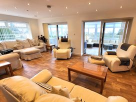 A living room with sofas and a coffee table at Top Of The Lane Luxury Holiday Apartment in Benllech