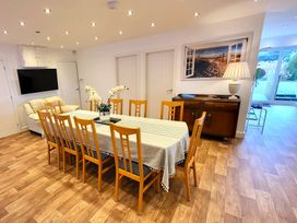 A dining room with a large table and chairs at Top Of The Lane Luxury Holiday Apartment in Benllech