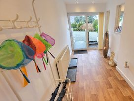 A hallway with colorful nets on a rack at Top Of The Lane Luxury Holiday Apartment Benllech