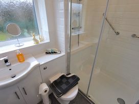 A bathroom with a shower and sink at Top Of The Lane Luxury Holiday Apartment in Benllech