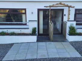 A front entrance with a pathway and garden at Top Of The Lane Luxury Holiday Apartment in Benllech