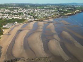 A beach with sand and water at Top Of The Lane Luxury Holiday Apartment in Benllech