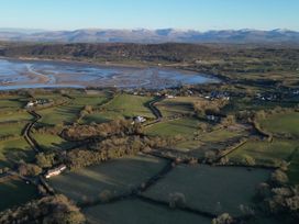 A landscape with fields and houses overlooking a river and mountains at Top Of The Lane Luxury Holiday Apartment Benllech