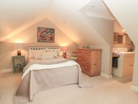 A bedroom with a bed and chest of drawers at Pudding Hill Barn Cottage Bibury