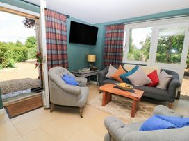 A living room with a sofa and armchair at Pudding Hill Barn Cottage Bibury