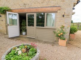 An entrance with a door and plants at Pudding Hill Barn Cottage in Bibury