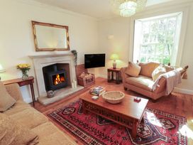 A living room with a fireplace and sofa at Garsdale Foot in Sedbergh
