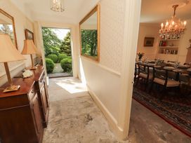 A hallway with lamps and a view to the garden at Garsdale Foot Sedbergh