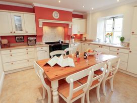 A kitchen with a table and chairs at Garsdale Foot in Sedbergh