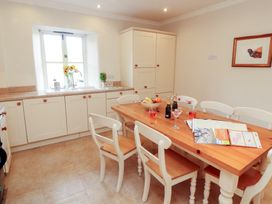 A kitchen with a table and chairs at Garsdale Foot in Sedbergh
