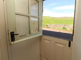An entryway with an open door and a view of green land at Garsdale Foot in Sedbergh