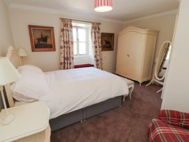 A bedroom with a bed and wardrobe at Garsdale Foot Sedbergh