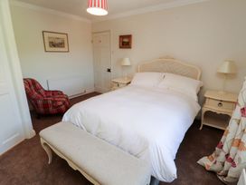 A bedroom with a bed and bedside tables at Garsdale Foot in Sedbergh