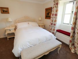 A bedroom with a bed and nightstands at Garsdale Foot in Sedbergh