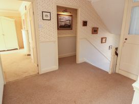 A hallway with a staircase and a cupboard at Garsdale Foot Sedbergh