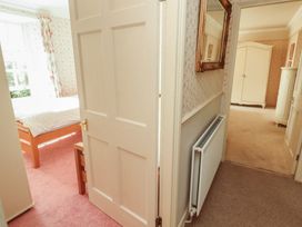 A bedroom with a bed and wardrobe at Garsdale Foot in Sedbergh