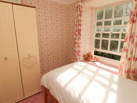 A bedroom with a bed and wardrobe at Garsdale Foot Sedbergh