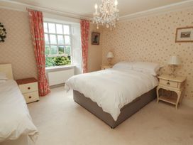 A bedroom with a bed and nightstands at Garsdale Foot in Sedbergh