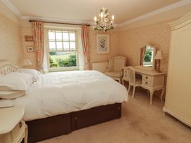 A bedroom with a bed and window at Garsdale Foot in Sedbergh