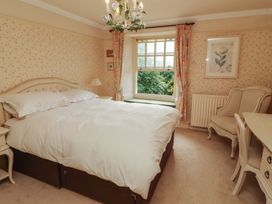 A bedroom with a bed and a window at Garsdale Foot in Sedbergh
