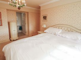 A bedroom with a bed and lamp at Garsdale Foot in Sedbergh