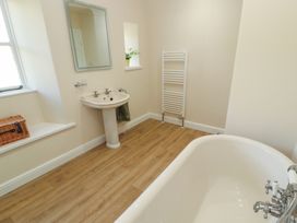 A bathroom with a bath tub and sink at Garsdale Foot in Sedbergh