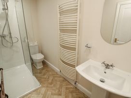 A bathroom with a shower, toilet, and sink at Garsdale Foot in Sedbergh