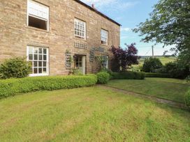 A garden with stone wall and plants at Garsdale Foot in Sedbergh
