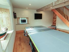 A game room with a ping pong table and a television at Garsdale Foot in Sedbergh