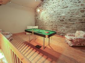 A snug with a pool table and sofa at Garsdale Foot in Sedbergh