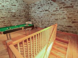 A game room with a pool table and wooden stairs at Garsdale Foot Sedbergh