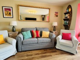 A living room with sofa and armchairs at Kippy Cottage in Truro