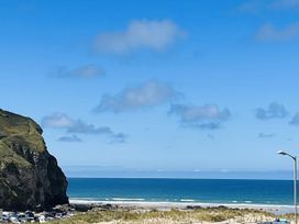 A view of the ocean and cliffs at Kippy Cottage in Truro